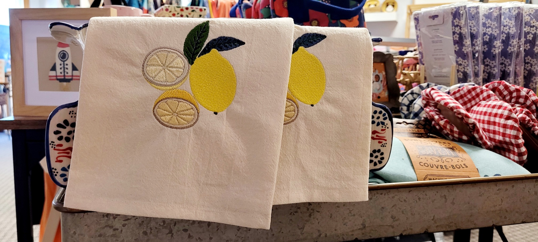 Lemon embroidery on cream kitchen towels at an Ignite Wonder display